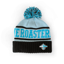 Load image into Gallery viewer, Knit Pom Pom Beanie featuring a light blue and black design with "Ice Roaster" text, topped with a bright turquoise pom pom and decorated with a small airplane emblem on the black ribbed cuff
