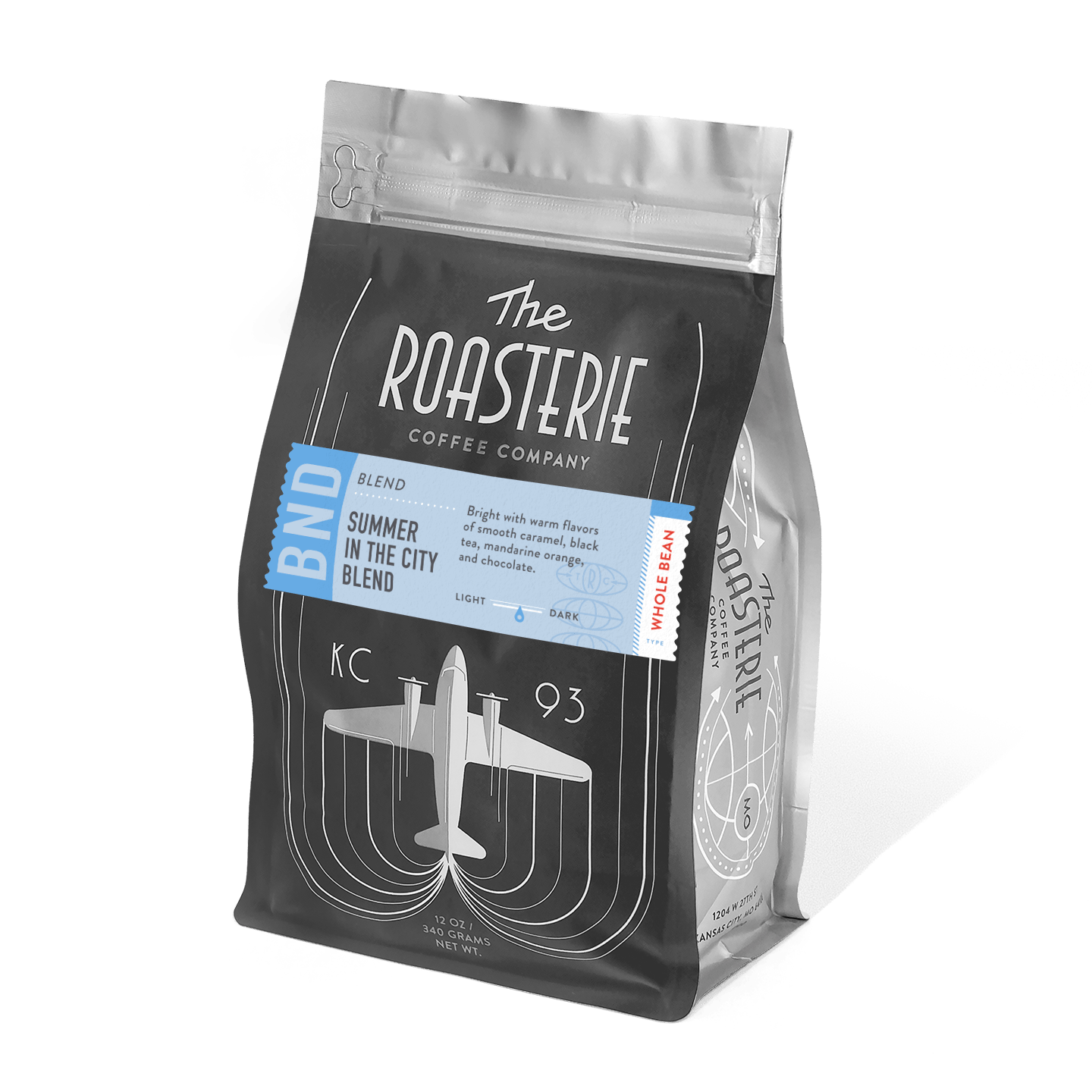 Summer In The City dark roast coffee blend by The Roasterie in a black resealable bag featuring vintage airplane design, perfect for cold brew with notes of dark chocolate, sweet almond and berry