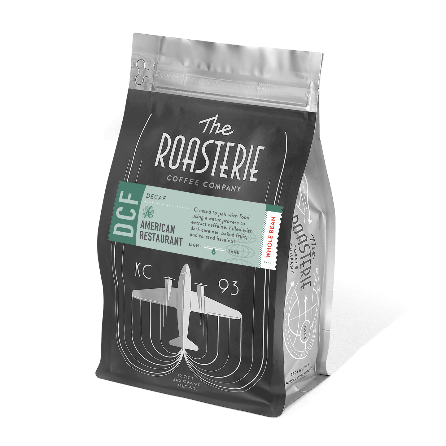 A bag of American Restaurant Decaf coffee from The Roasterie featuring a black package design with an airplane illustration and teal label. The artisanal coffee promises dark caramel, baked fruit, and toasted hazelnut flavors.