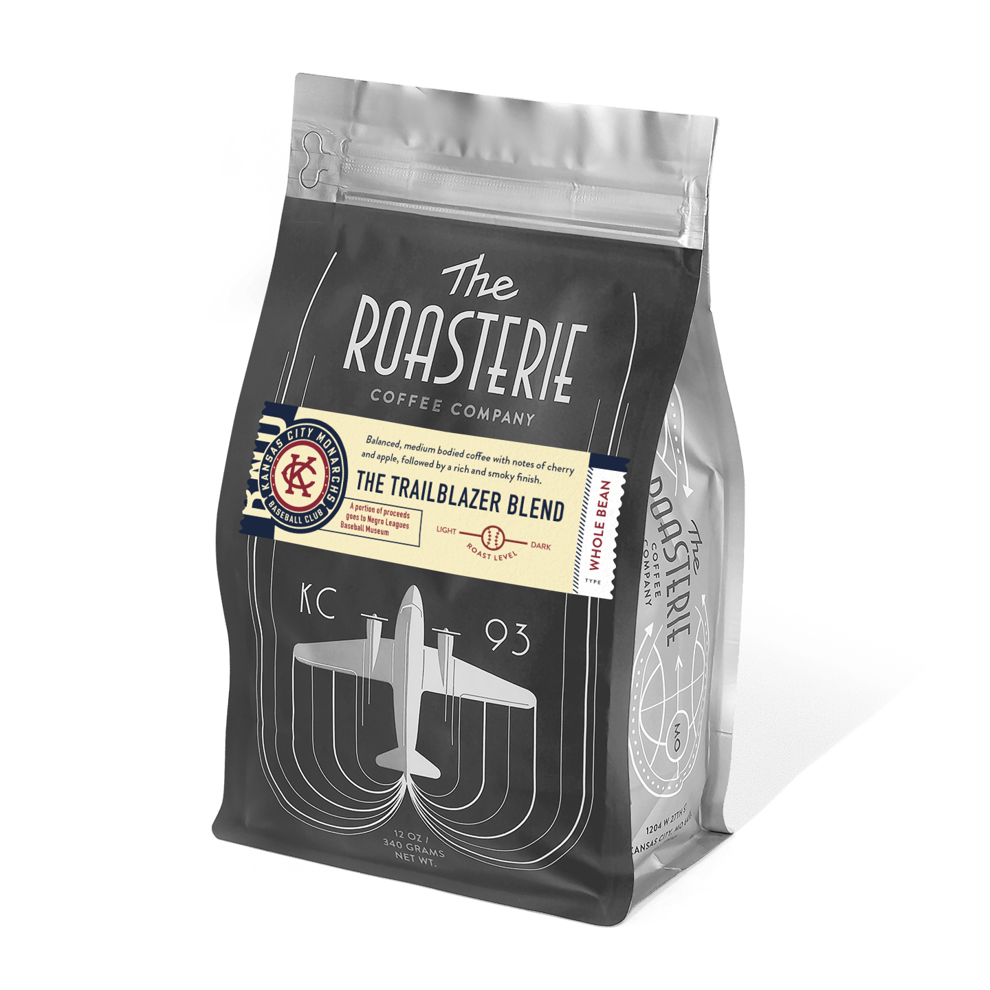 The Roasterie Trailblazer Blend coffee bag featuring vintage-inspired black packaging with art deco airplane design, KC 93 text, and cream-colored label, benefiting the Negro Leagues Baseball Museum.