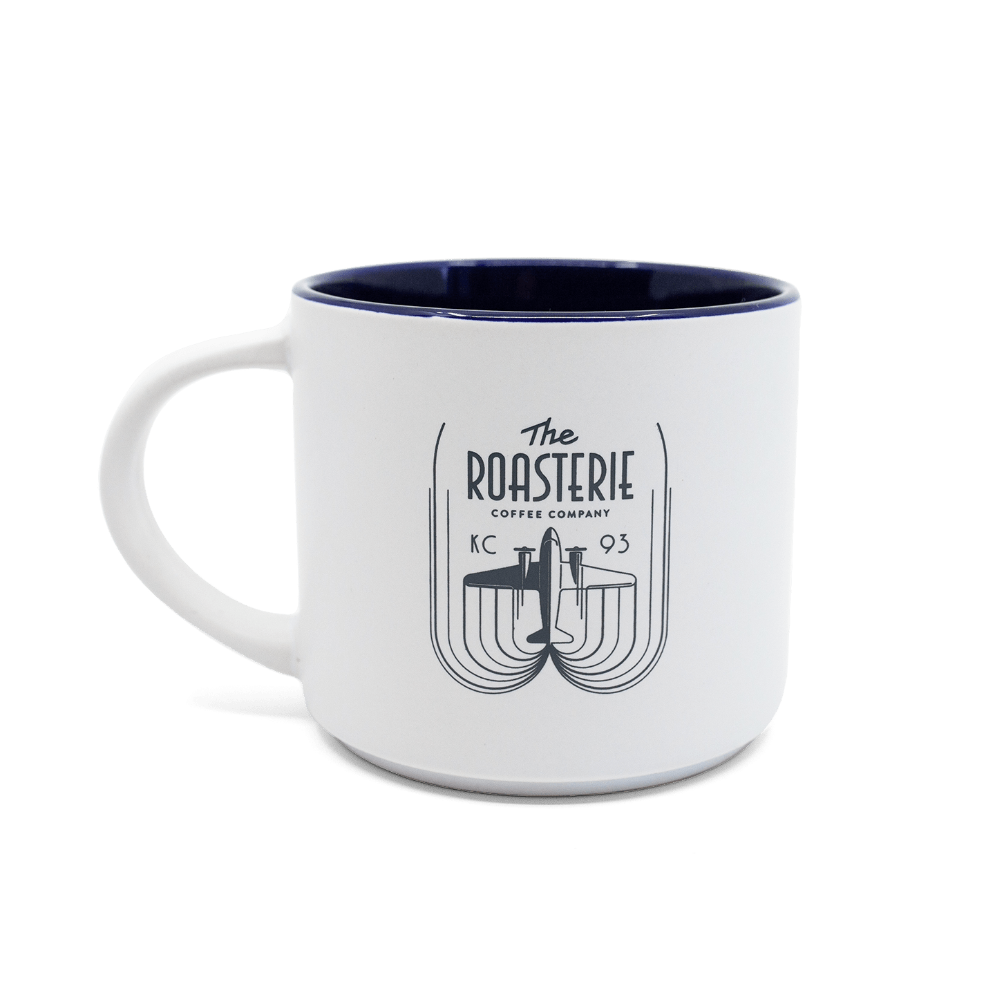 Roasterie DC-3 White Blue Mug featuring a minimalist white ceramic design with navy interior and retro-style logo depicting DC-3 airplane in black linework. Thick-walled coffee mug with classic curved handle and modern artistic branding element.